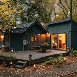 a small cabin with a deck in the woods