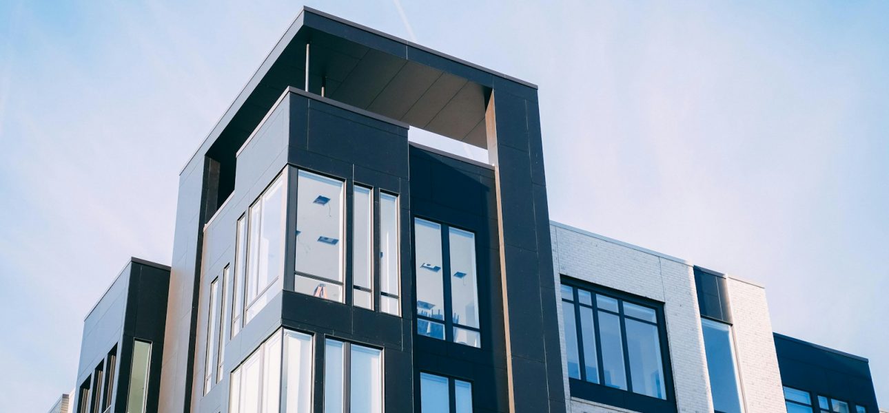 black and white cocnrete building low-angle photography