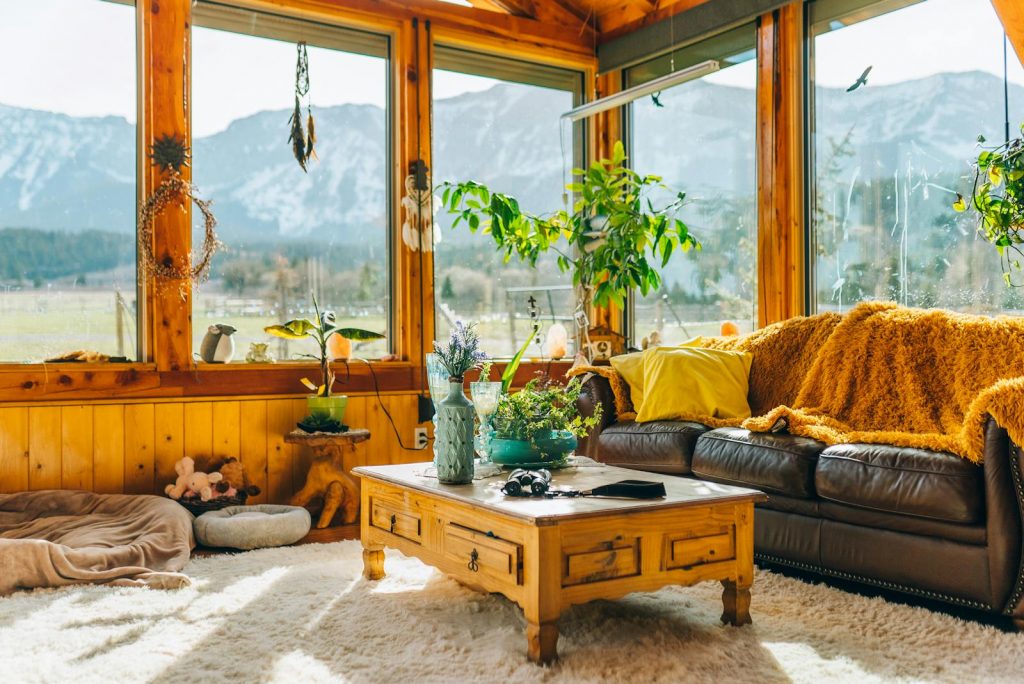Warm and inviting interior living room with stunning mountain views through large windows.