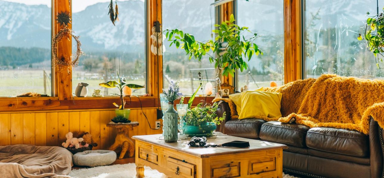 Warm and inviting interior living room with stunning mountain views through large windows.