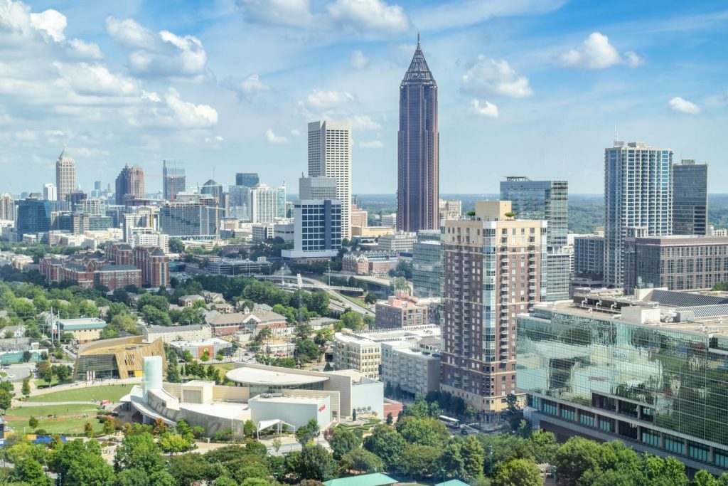 A breathtaking aerial view of the Atlanta skyline with high-rise buildings under a clear blue sky.