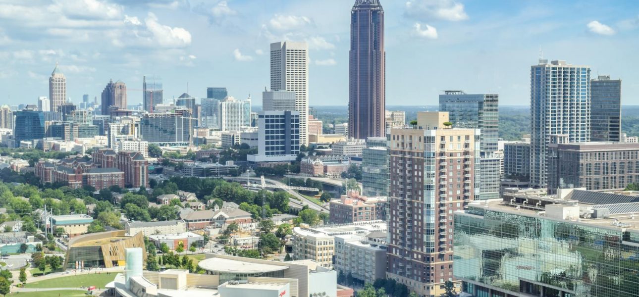 A breathtaking aerial view of the Atlanta skyline with high-rise buildings under a clear blue sky.