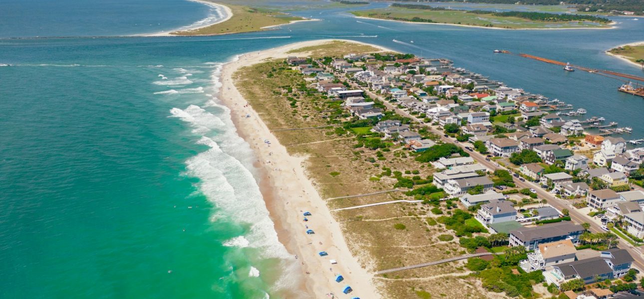 a beach with houses and water