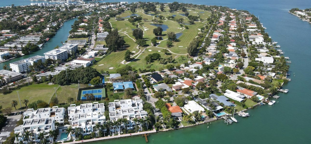 aerial view of city buildings near body of water during daytime
