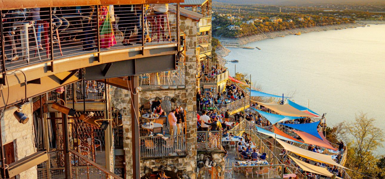 a crowd of people standing on top of a tall building
