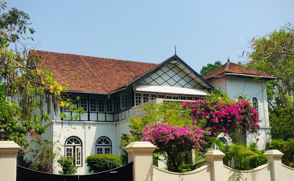 a large white house with a black gate