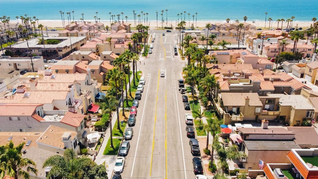 Explore Huntington Beach's beautiful neighborhood and coastline in this vibrant aerial shot.