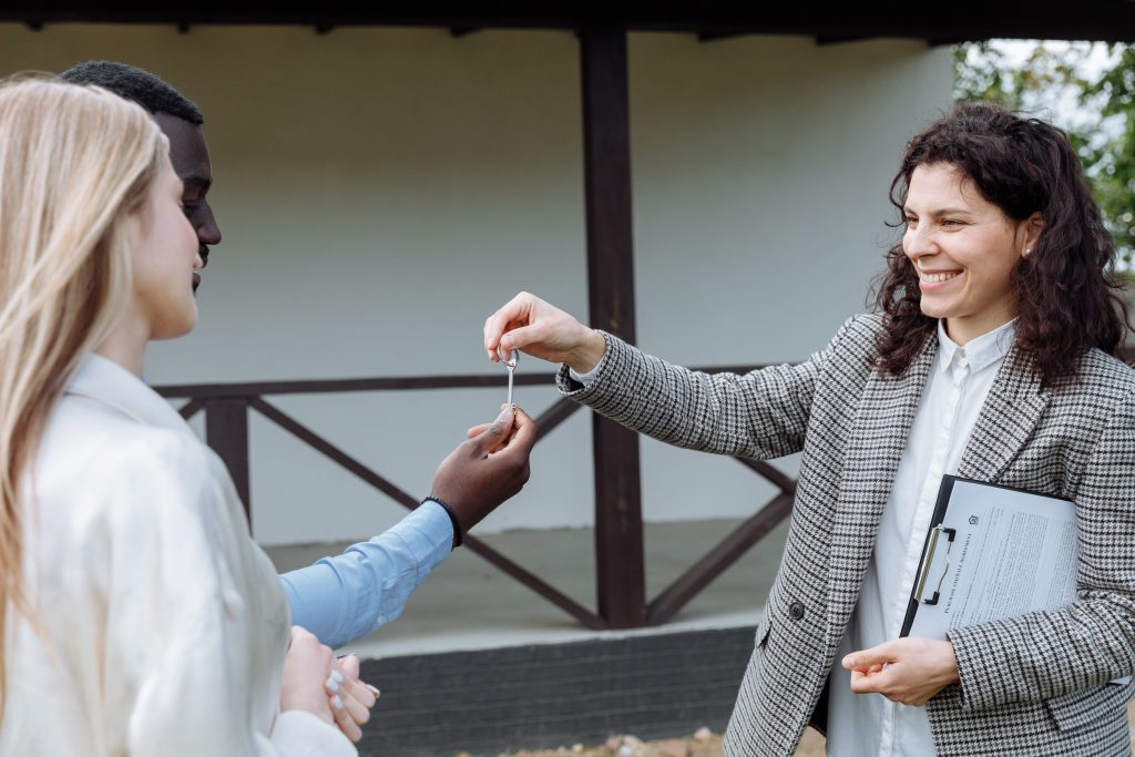 Real estate agent handing over house keys