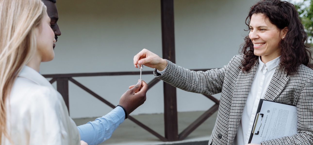 Real estate agent handing over house keys