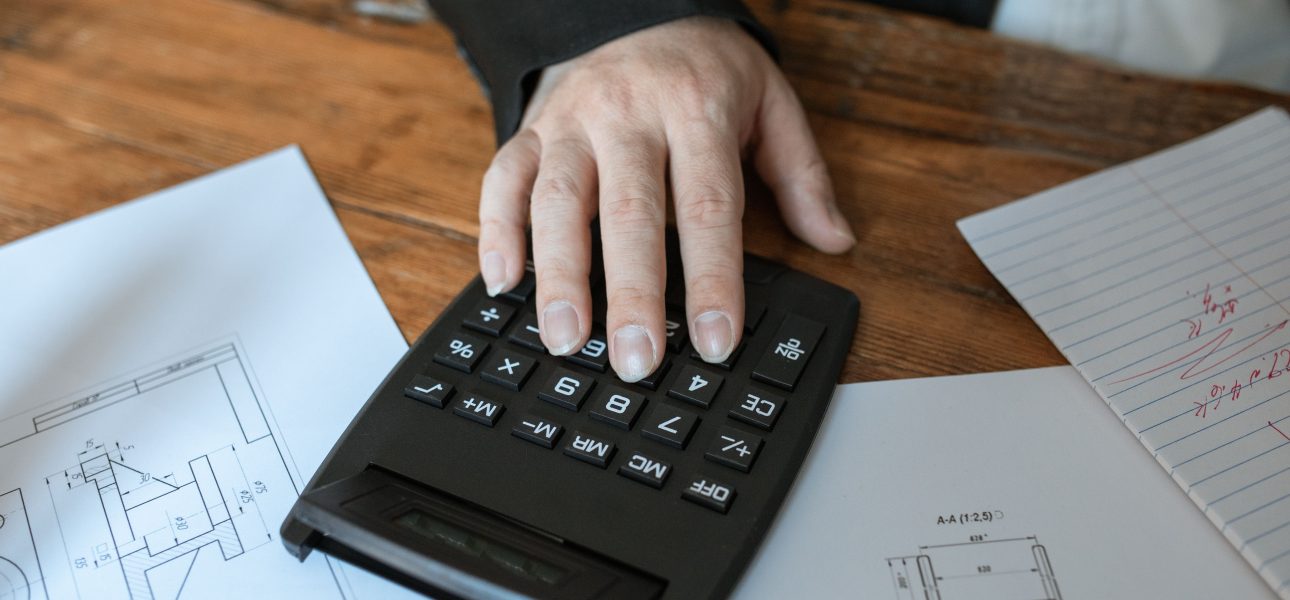 Accountant working at a desk with a calculator