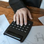 Accountant working at a desk with a calculator