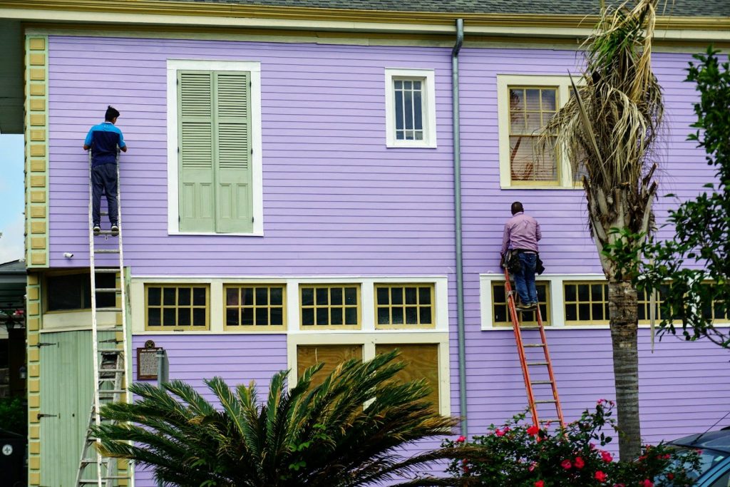 Crew repainting the exterior of an American clapboard house