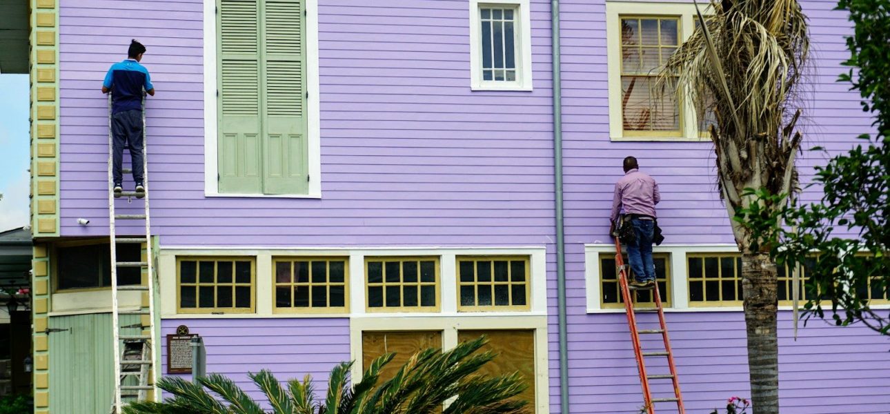 Crew repainting the exterior of an American clapboard house