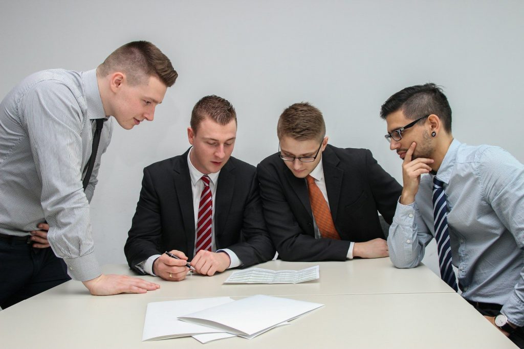 Executives reviewing documents, evaluating transitional real estate lending risk