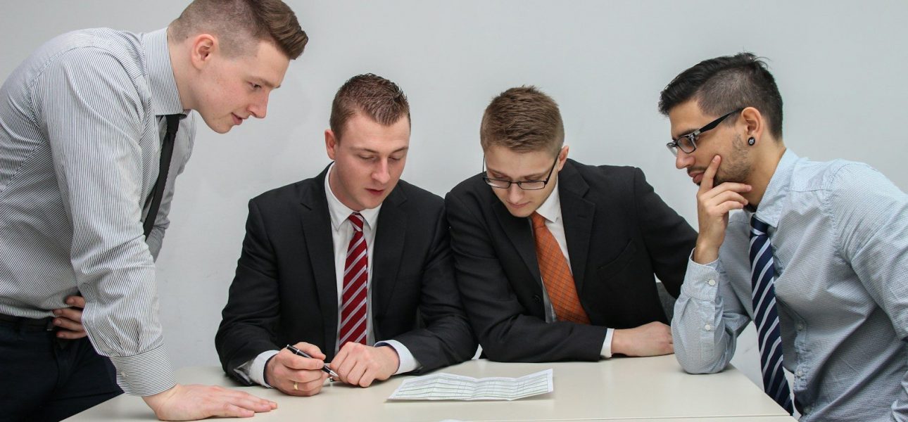 Executives reviewing documents, evaluating transitional real estate lending risk
