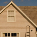 Full-color photo of an American single-family suburban home being repainted with a ladder, representing SFR and RTL renovation financing