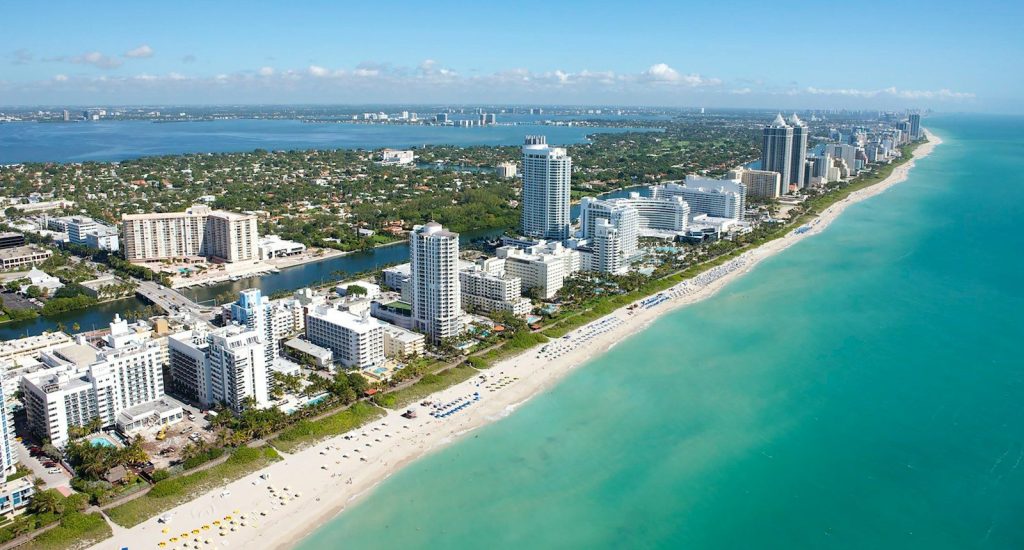 An aerial view of the coastline and high-rise buildings in Miami Beach, Florida