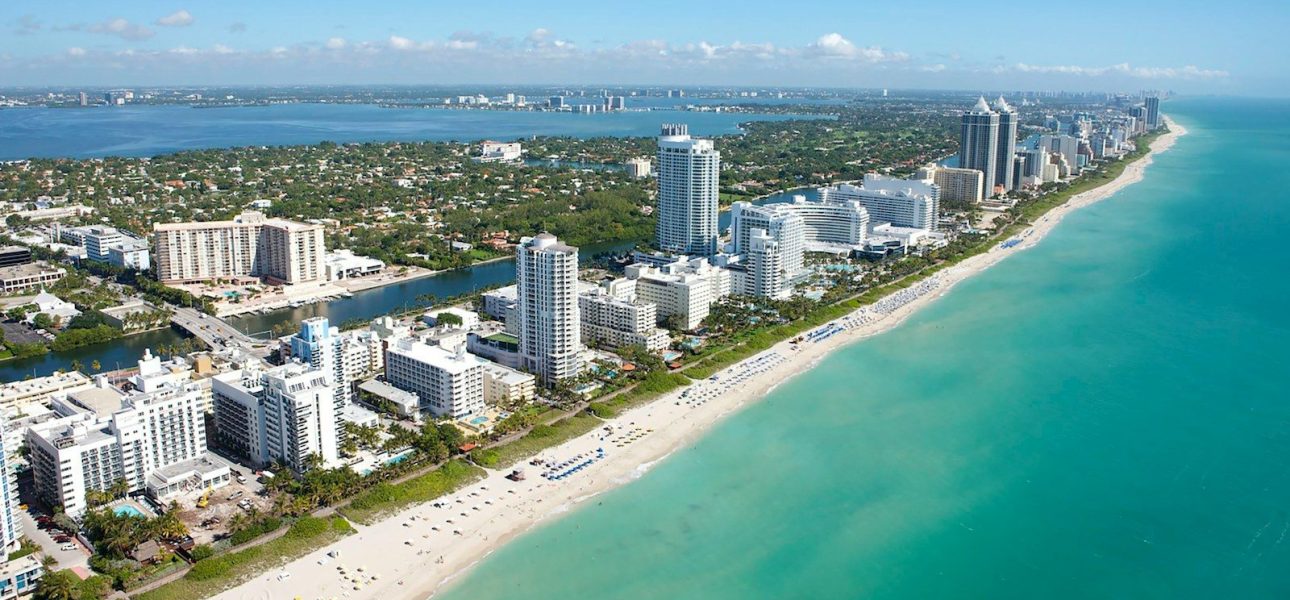 An aerial view of the coastline and high-rise buildings in Miami Beach, Florida