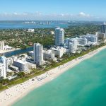 An aerial view of the coastline and high-rise buildings in Miami Beach, Florida