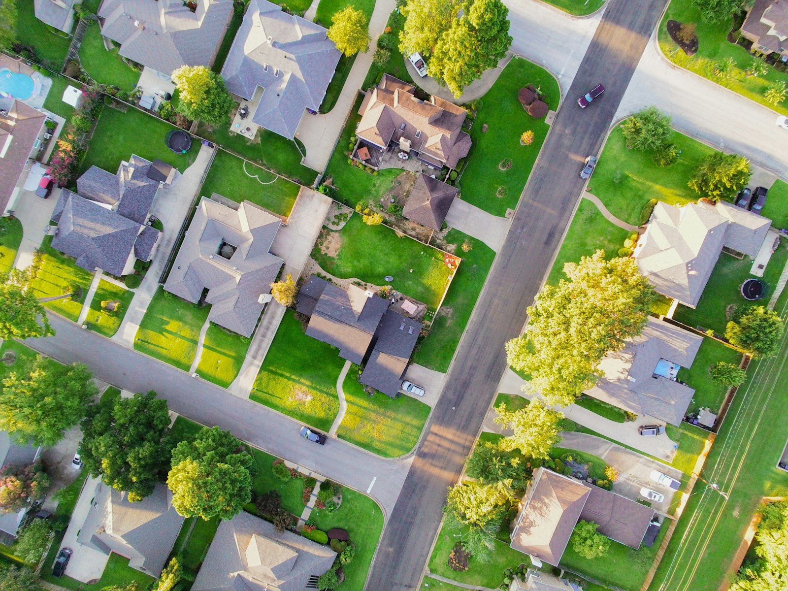 Overhead aerial view of single-family homes in a leafy suburban neighborhood