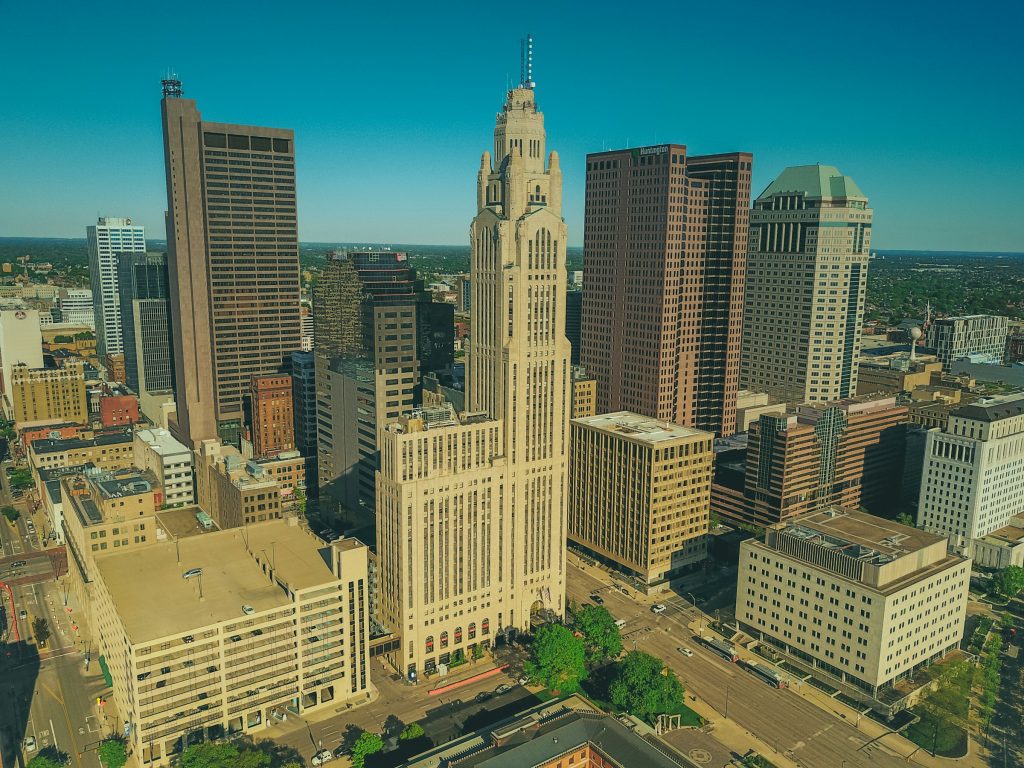 Full-color aerial photo of downtown Columbus, Ohio, under a clear blue sky
