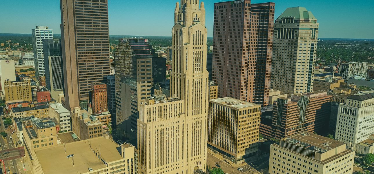 Full-color aerial photo of downtown Columbus, Ohio, under a clear blue sky