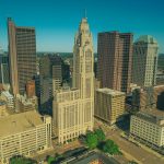 Full-color aerial photo of downtown Columbus, Ohio, under a clear blue sky