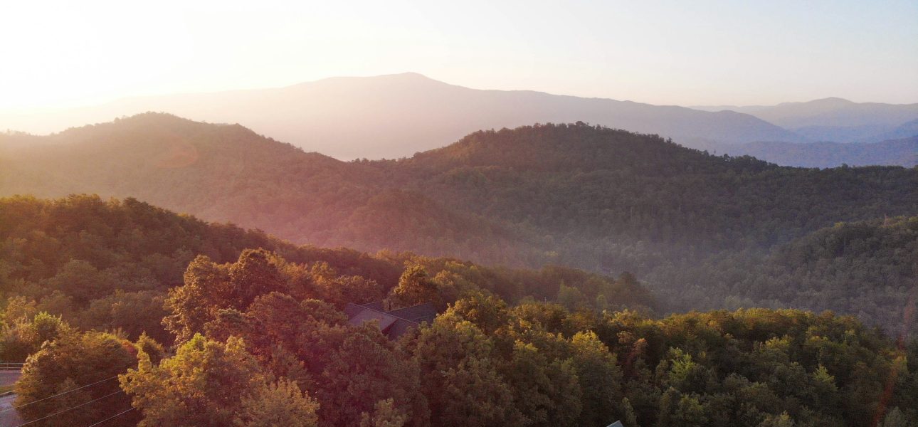 Full-color photo of a mountain cabin short-term rental exterior in the Smoky Mountains of Tennessee